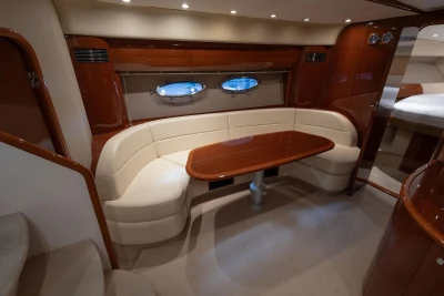 Luxurious interior of 2007 Princess V48 yacht with elegant seating and wooden table.