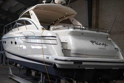 2007 Princess V48 yacht in a warehouse, showcasing sleek design and luxury features.