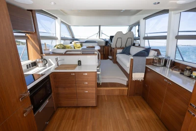 Luxurious interior of 2022 Princess F50 yacht with modern kitchen and seating area.