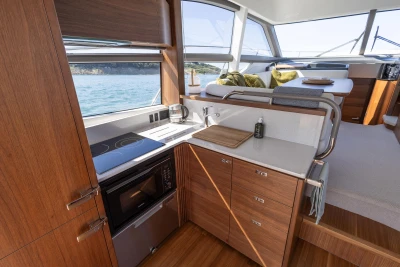 Luxurious interior of 2022 Princess F50 yacht with modern kitchen and scenic ocean view.