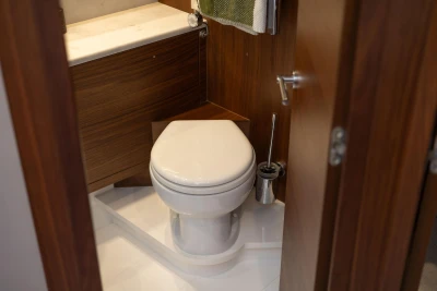 Luxurious bathroom in 2022 Princess F50 yacht with wooden cabinetry and modern fixtures.