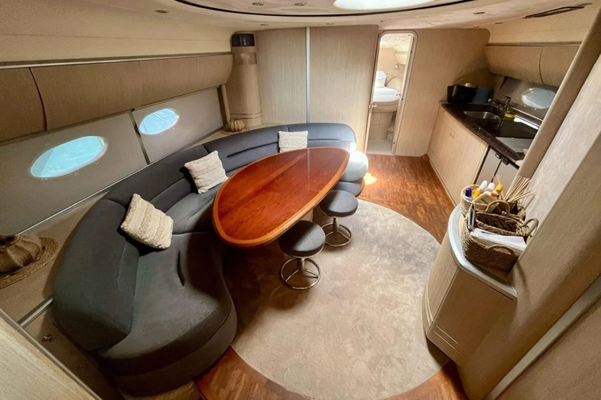 Luxurious interior of 2005 Princess V58 yacht with elegant seating and dining area.