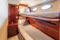 Interior of 2005 Princess V58 yacht with cozy twin bunk beds and wooden cabinetry.