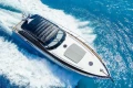 Luxurious 2005 Princess V58 yacht cruising on vibrant blue ocean waters.