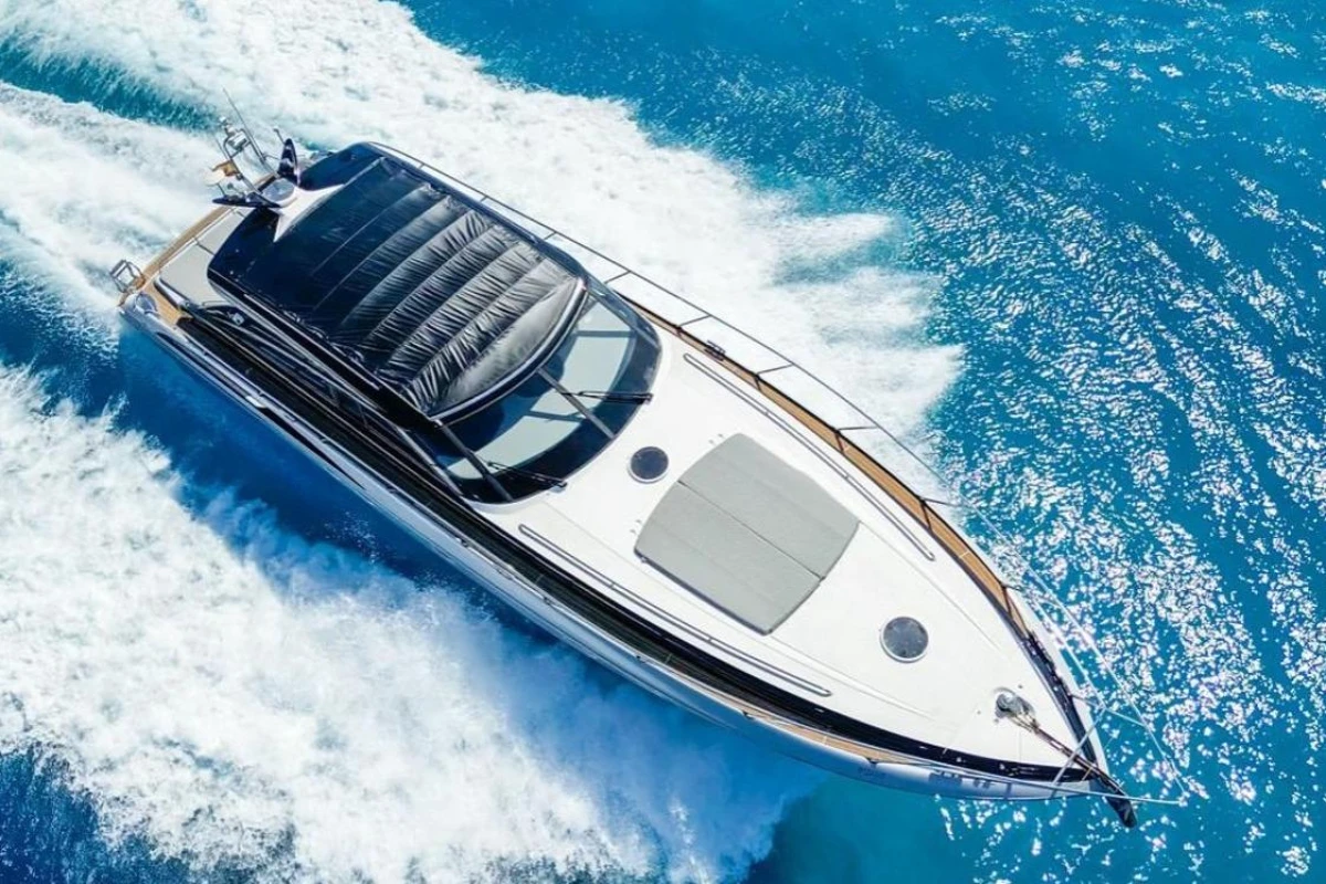 Luxurious 2005 Princess V58 yacht cruising on vibrant blue ocean waters.