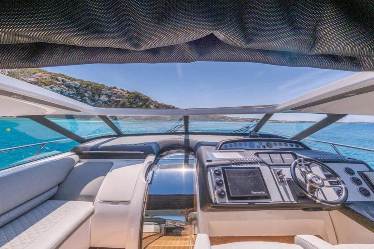 Interior view of 2005 Princess V58 yacht cockpit with scenic ocean backdrop.