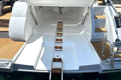 2005 Princess V58 yacht with open storage compartment and wooden steps.