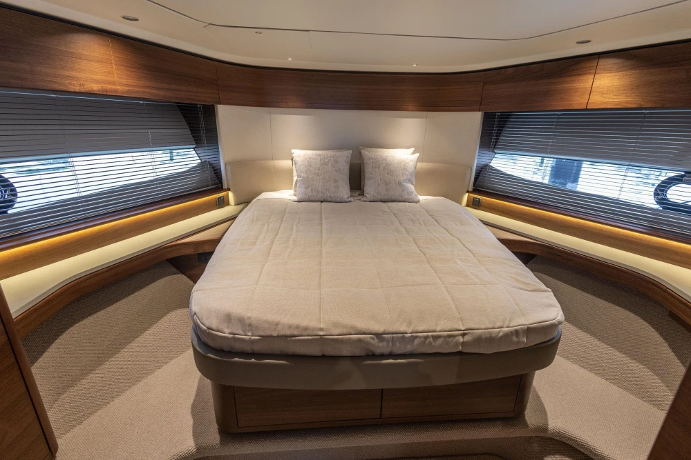 Luxurious bedroom interior of 2025 Princess S65 yacht with modern design and cozy ambiance.