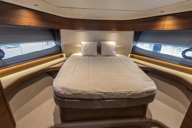 Luxurious bedroom interior of 2025 Princess S65 yacht with modern design and cozy ambiance.