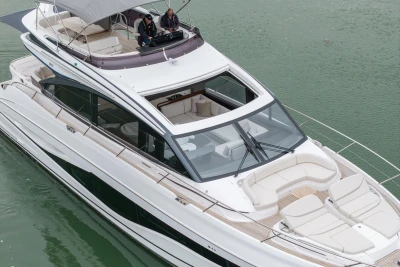 Luxurious 2025 Princess S65 yacht cruising on calm waters, showcasing elegant design and spacious deck.