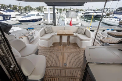 Luxurious 2025 Princess S65 yacht deck with elegant seating and marina view.