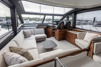 Luxurious interior of 2025 Princess S65 yacht with modern seating and panoramic windows.