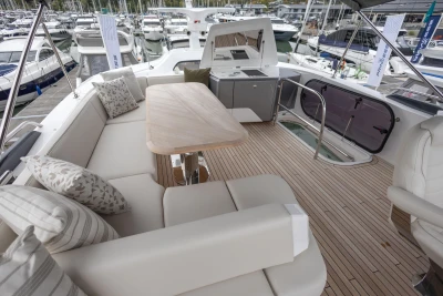 Luxurious 2025 Princess S65 yacht deck with elegant seating and wooden table.