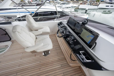 Luxurious 2025 Princess S65 yacht helm with modern navigation systems and plush seating.