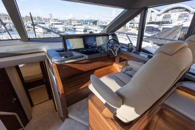 Luxurious 2026 Princess F58 yacht helm with modern navigation system and plush seating.