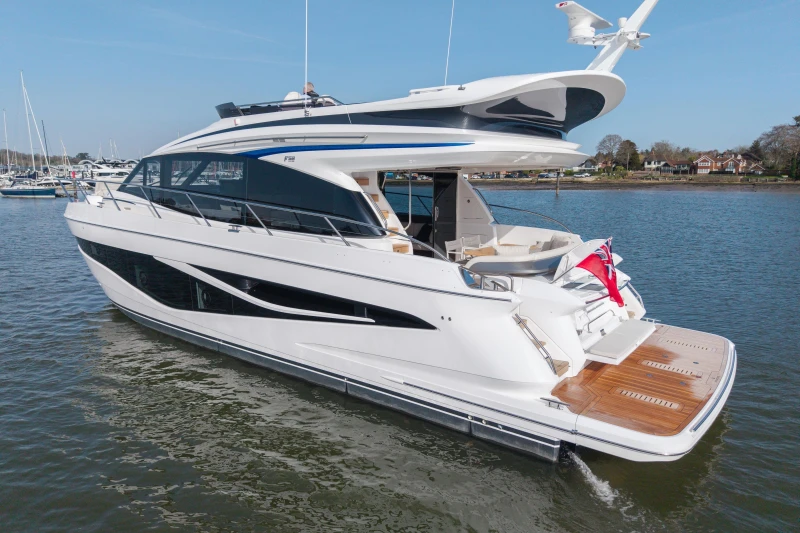 Luxurious 2026 Princess F58 yacht cruising on calm waters, showcasing sleek design and elegance.